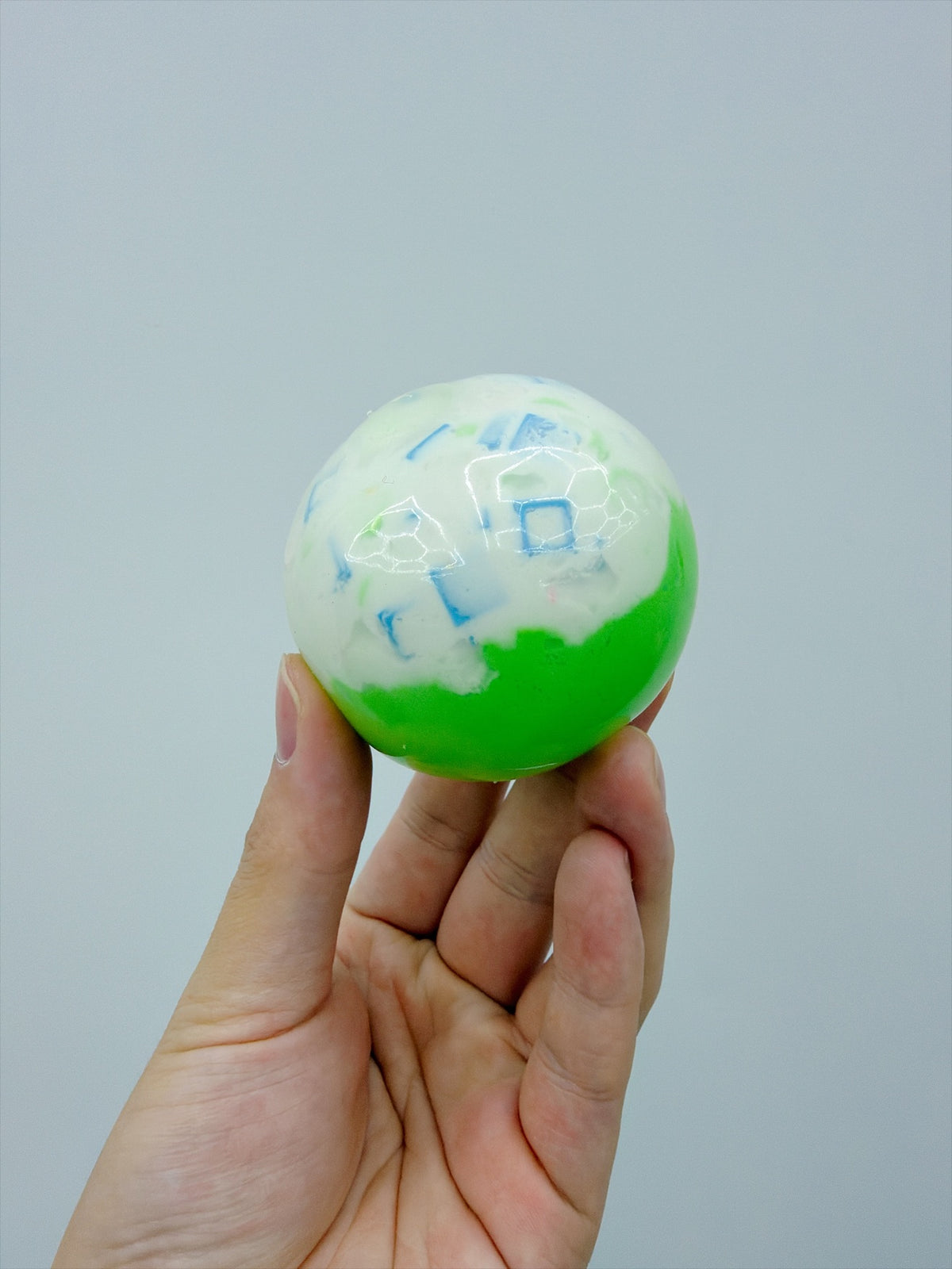 Real Touch Me two-tone crunchy ball squishy in Green in hand
