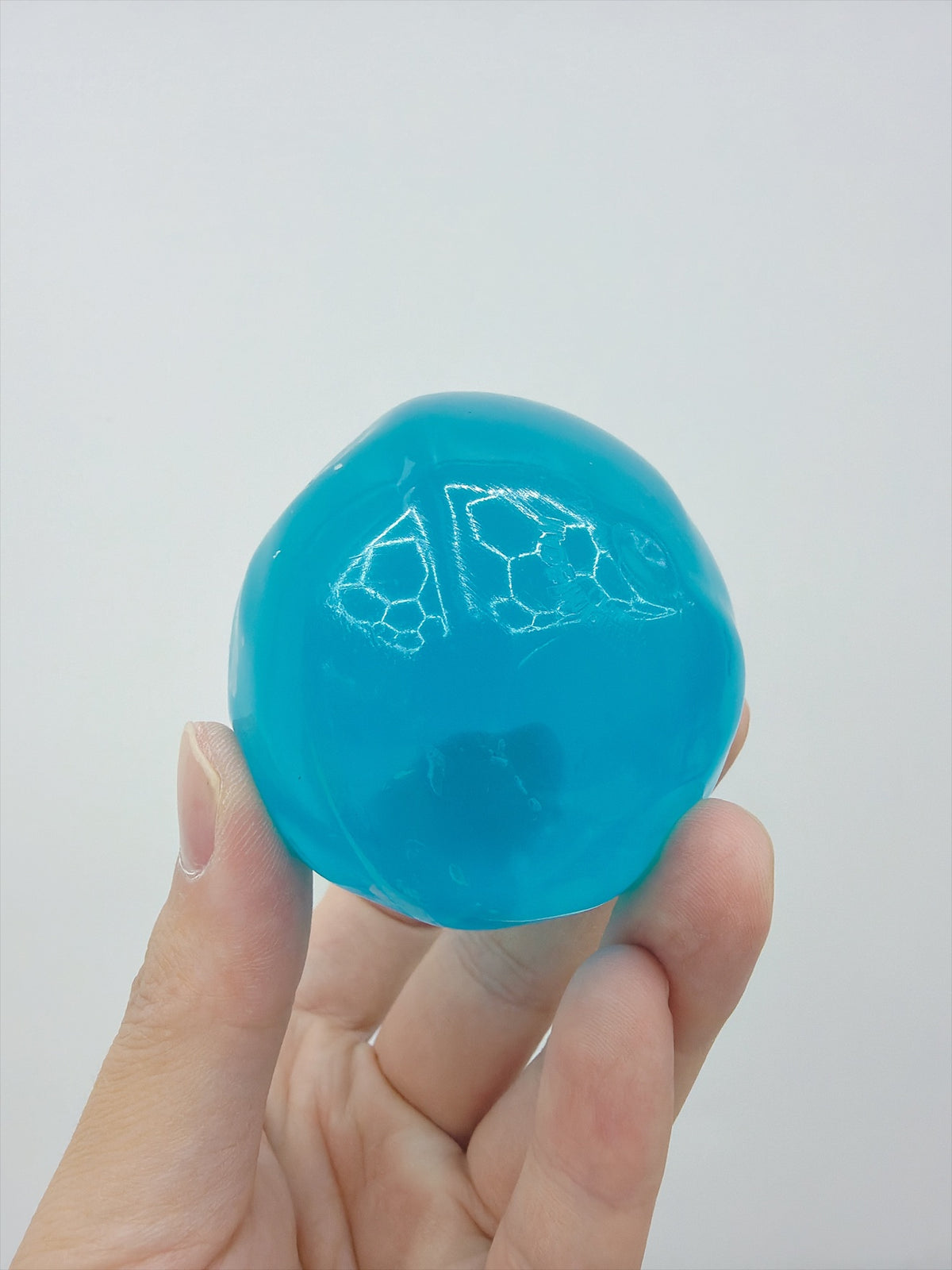 Real Touch Me clear Vaseline ball squishy in Blue in hand