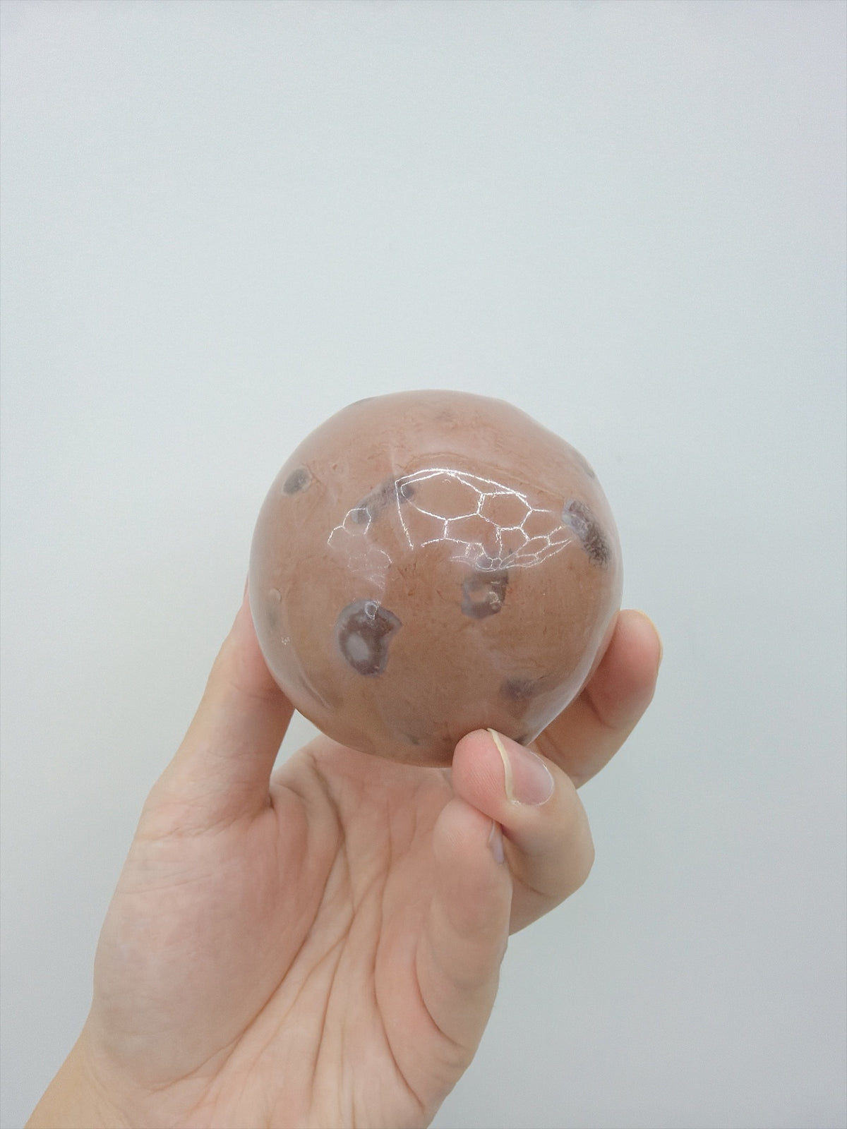 Real Touch Me cocoa soft crunchy ball squishy in hand