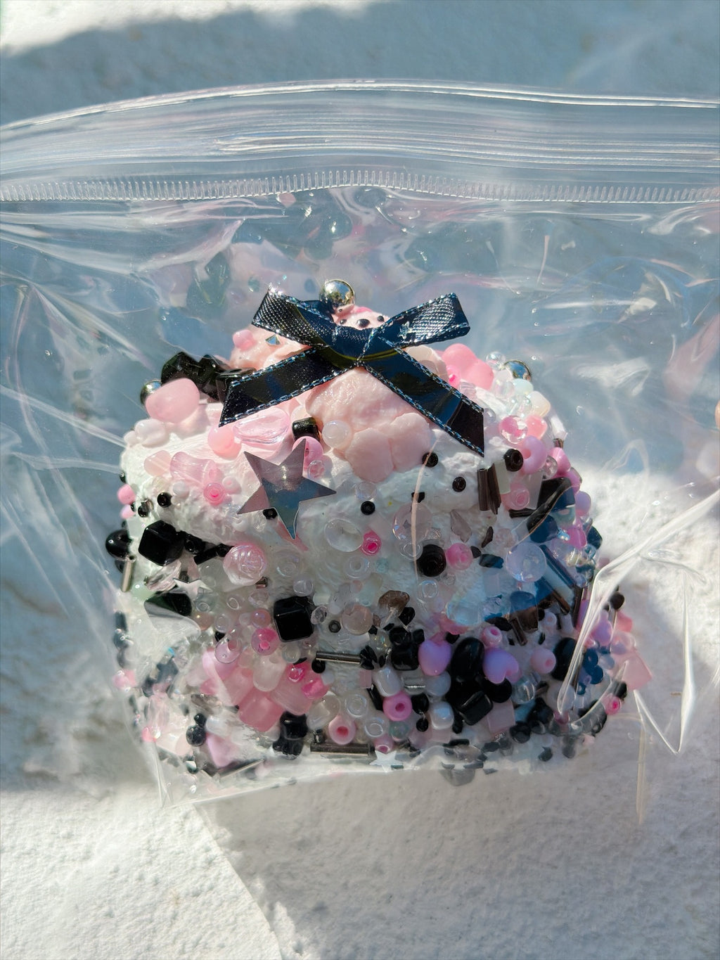 Jewel Drop black bow bead squishy, close-up