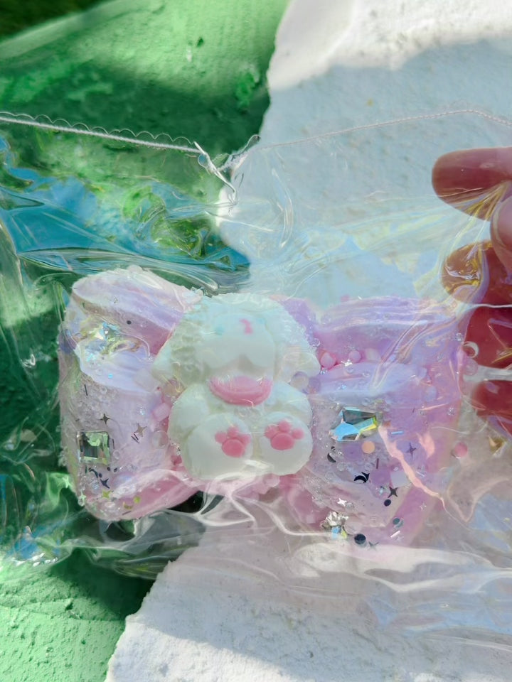 Squeezing the Jewel Drop pink bow bunny squishy