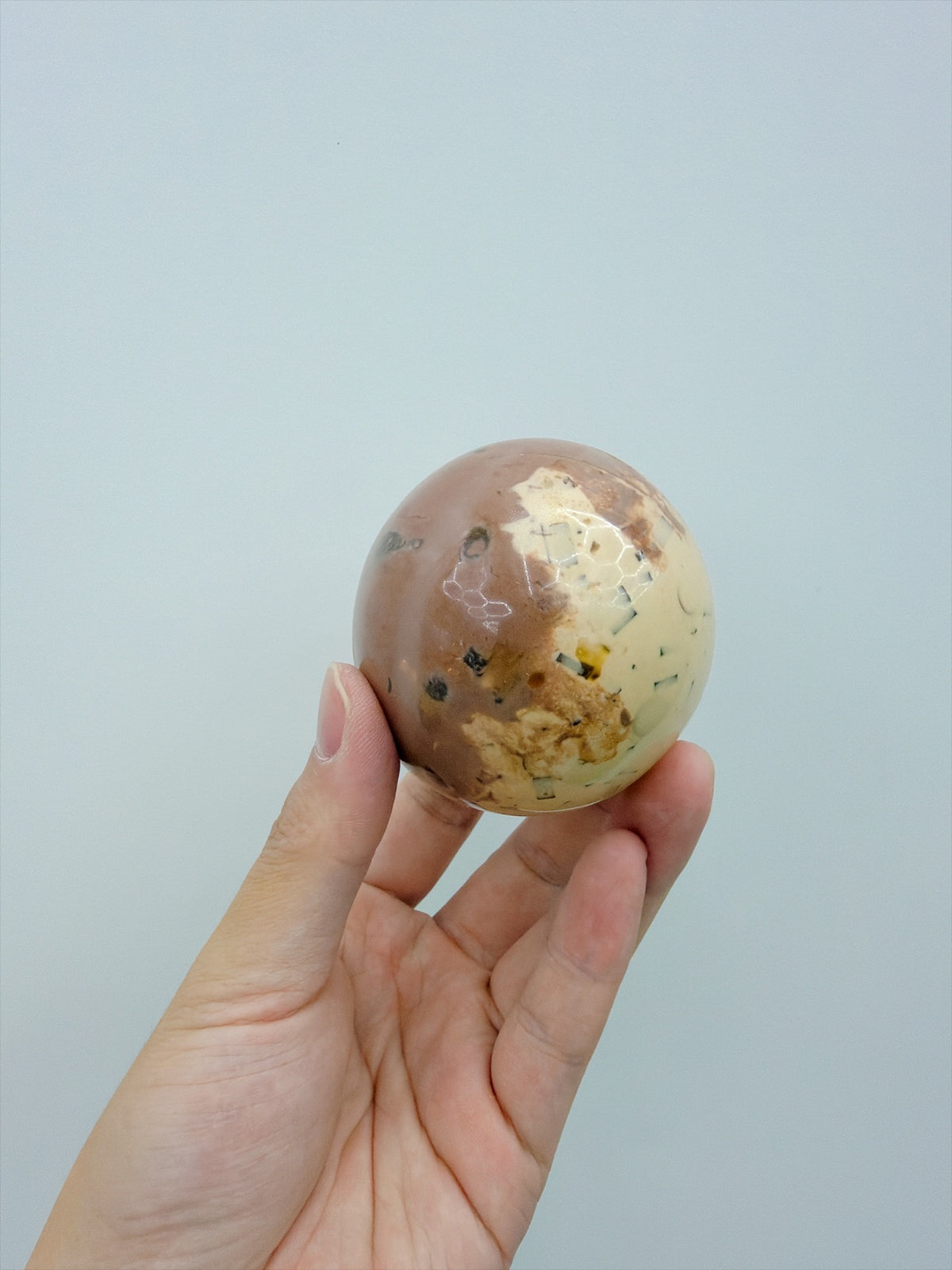Real Touch Me coffee cocoa ball squishy, glossy marbled side close-up