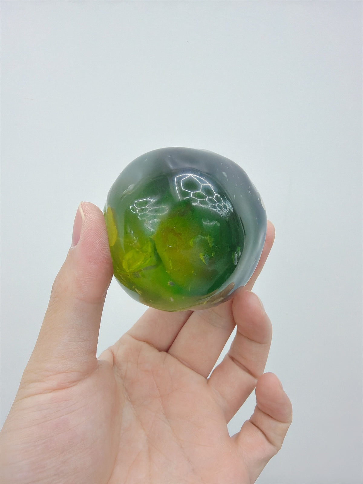 Real Touch Me Vaseline green plum ball squishy in hand