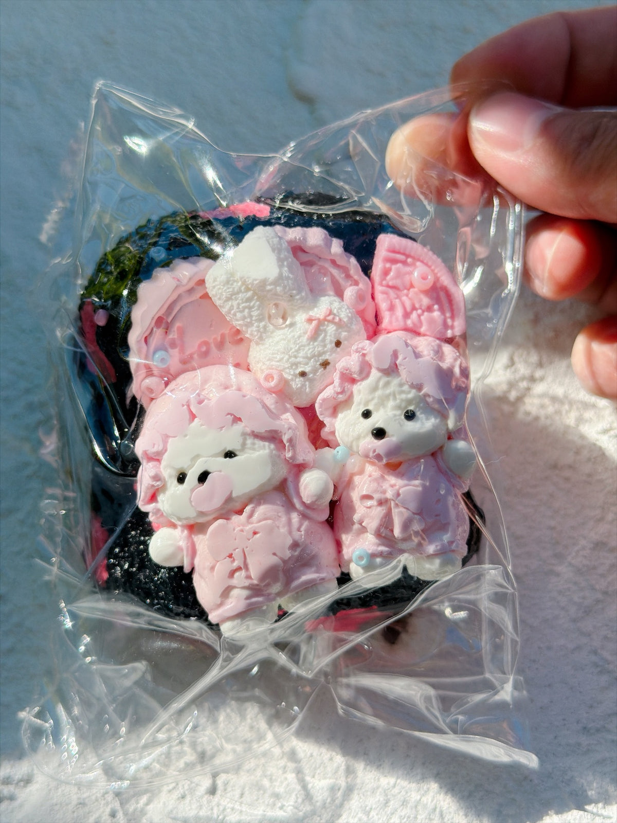 Wonder Village black pink bear squishy with pink bear figures, white bunny and pink cookies, in a clear bag