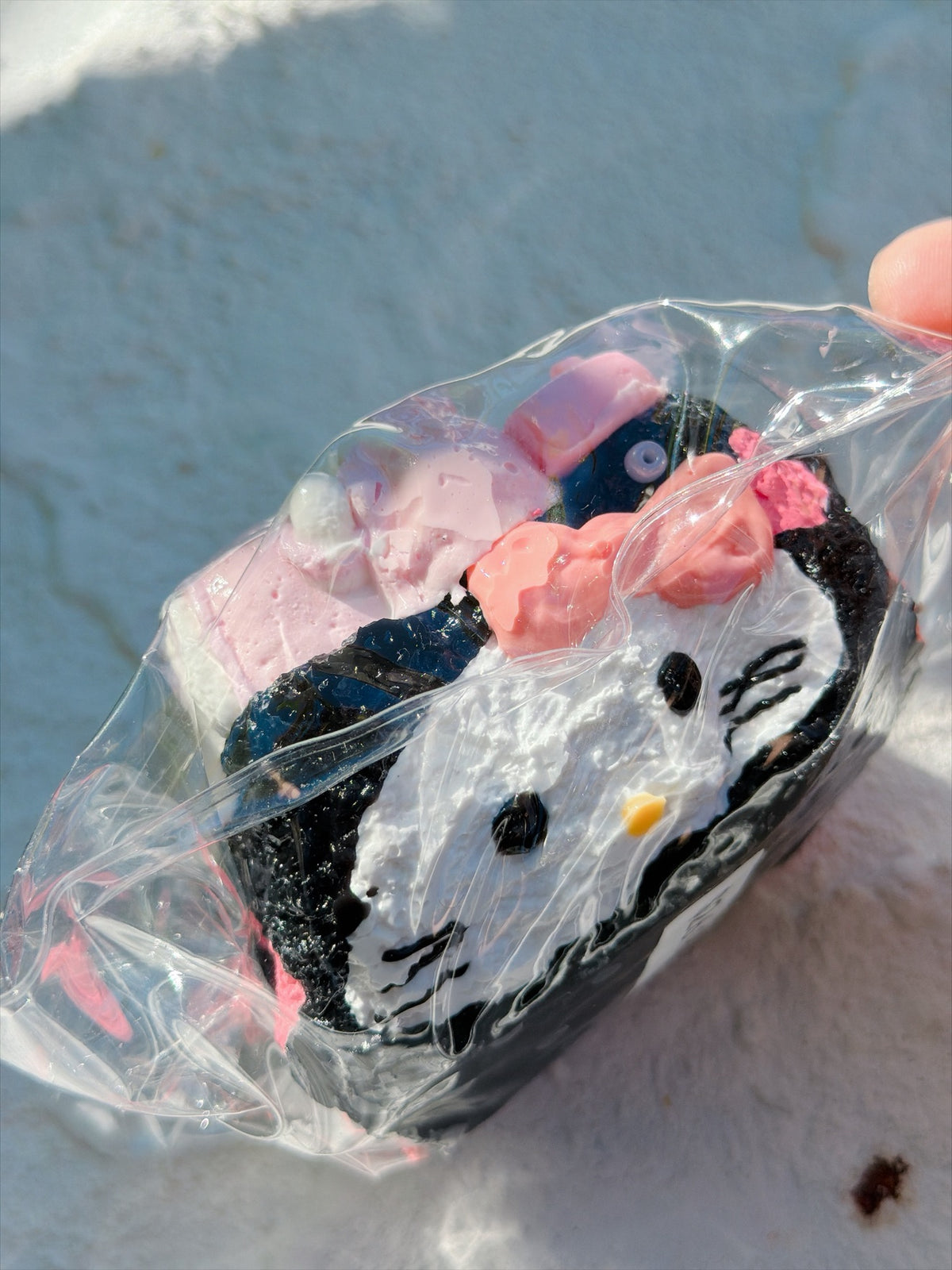 Wonder Village black pink bear squishy, white cat face with pink bow, in a clear bag