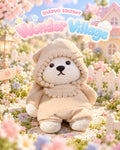Wonder Village hooded bear squishy in a beige hooded outfit with bead trim, in a miniature village scene