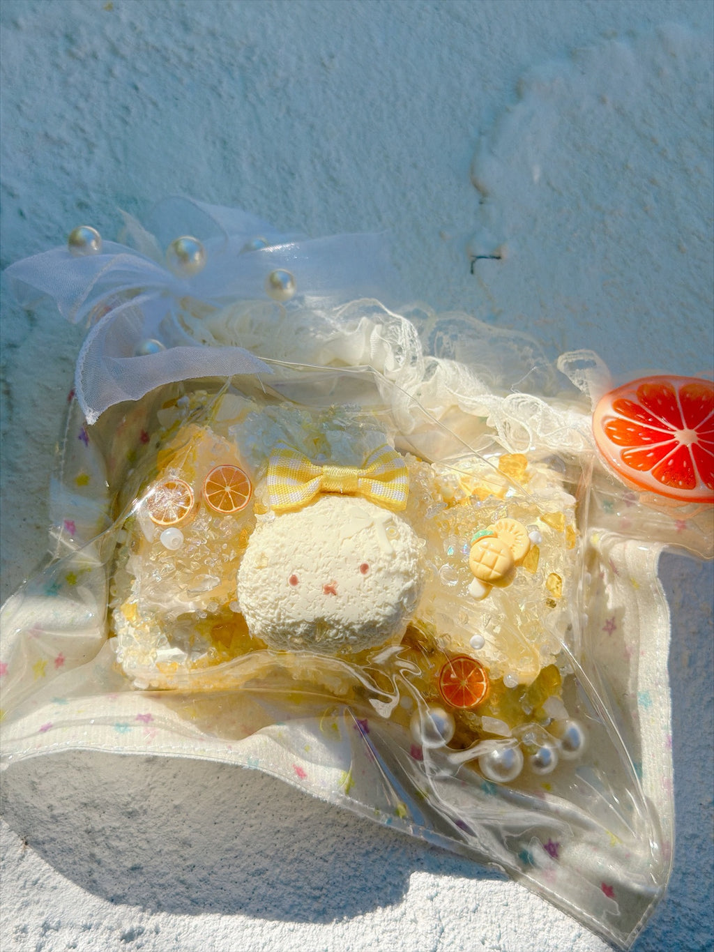 Wonder Village lemon bunny squishy with yellow bow, orange slices and pearls, in a clear bag