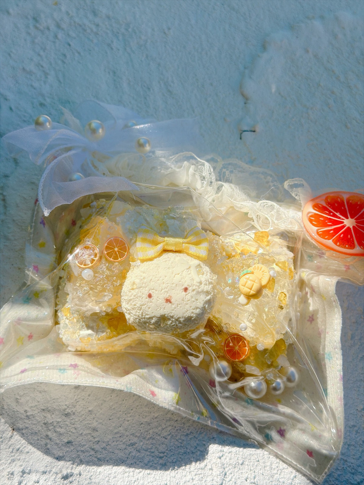Wonder Village lemon bunny squishy with yellow bow, orange slices and pearls, in a clear bag