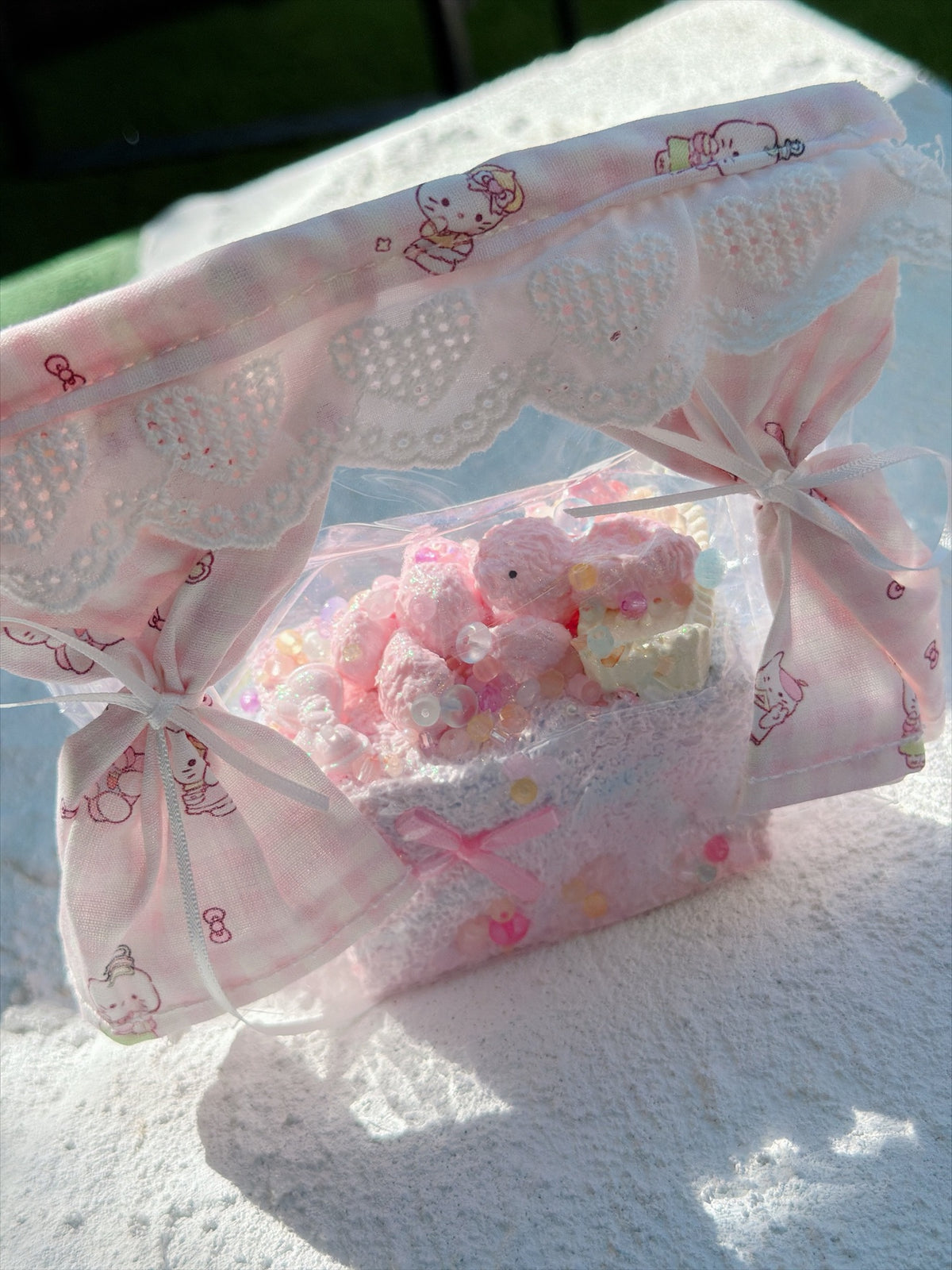 Wonder Village pink basket squishy in a pink lace basket, close view